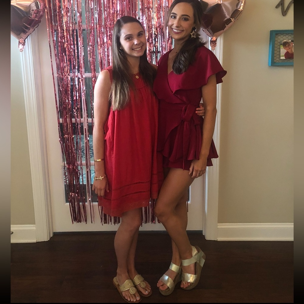 Beautiful garnet/burgundy romper with tie detail, ruffles, and open back